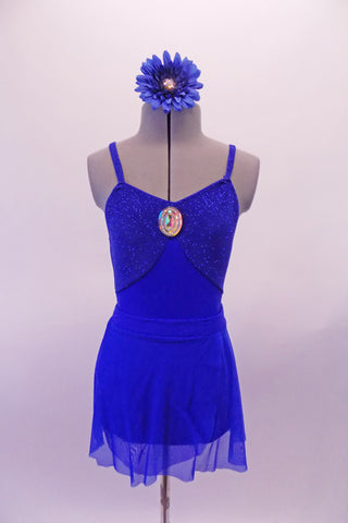 Royal blue leotard has a glittery bust the is accented with a large jewelled accent. The leotard is complemented by a matching sheer short sarong-type skirt. Comes with a jewelled blue floral accessory. Front