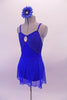 Royal blue leotard has a glittery bust the is accented with a large jewelled accent. The leotard is complemented by a matching sheer short sarong-type skirt. Comes with a jewelled blue floral accessory. Side