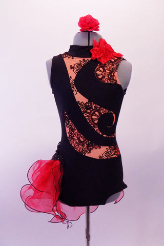 Black leotard has a black lace print on nude, inlaid in a swirled pattern across the torso & open back. The left side of the neck has a red ruffle.  A double layered red curly hemmed side bustle sits along the right hip & back accented with black beaded appliques. Comes red with a red floral hair accessory. Front