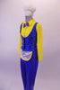 3-piece costume has a bright yellow button front collared shirt with attached blue bow tie. A blue pinstripe black polka dot vest that gathers at the back sits over the shirt & compliments the blue stretch fabric trousers with an attached white mini apron. Comes with white plush chef hat accessory with elastic. Left side