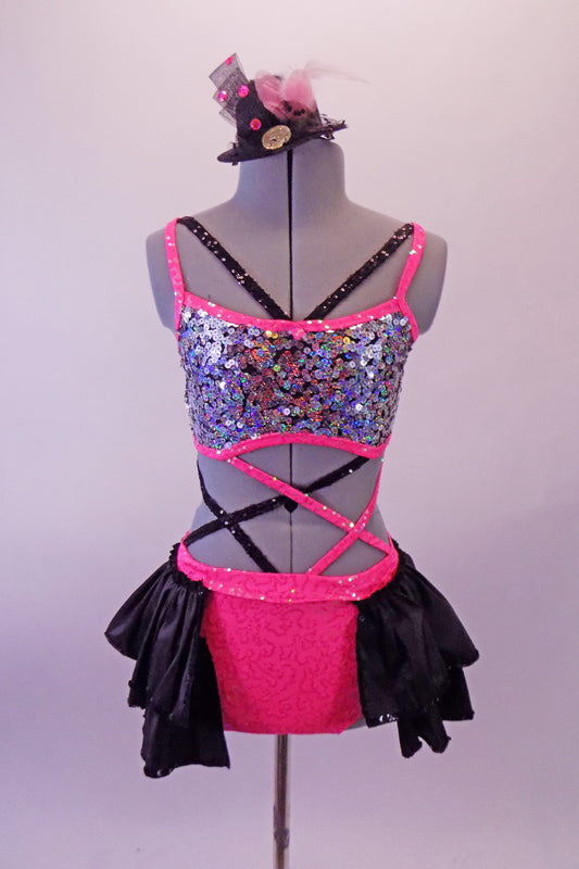 Iridescent fully sequined, strappy half-top & pink sequined brief with attached open front ruffled black bustle skirt. The pieces are connected by a series of criss-cross black & pink straps at the front and sides. The back of the half-top laces up to match the theme. Comes with a black mini top hat accessory. Front