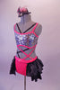 Iridescent fully sequined, strappy half-top & pink sequined brief with attached open front ruffled black bustle skirt. The pieces are connected by a series of criss-cross black & pink straps at the front and sides. The back of the half-top laces up to match the theme. Comes with a black mini top hat accessory. Left side