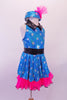 Turquoise fully sequined, silver polka dot halter dress has black waistband and collar. Hot pink ruffled petticoat sits beneath the dress and compliments the matching polka dot pill hat with pink pouffe accent. Right side