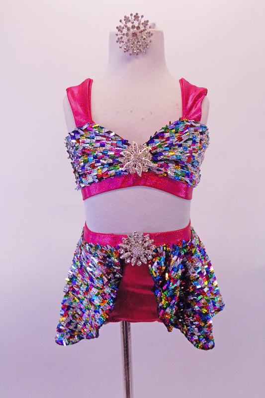 2-piece costume is a colourful rectangular sequined fabric, The half-top has a lace-up corset back, wide hot pink straps & large crystal cluster brooch accent. The matching bottom is a hot pink brief with an attached sequined, open front skirt & crystal cluster brooch. Comes with matching crystal hair accessory. Front