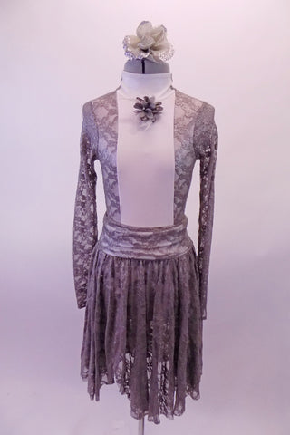 Grey lace leotard has long lace sleeves and an open back. The high-neck closed front has a white center torso with a floral accent. The matching lace, knee-length pull-on skirt has a wide waistband to accent the leotard. Comes with silver lace floral hair accessory. Front