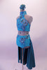 Two-piece turquoise costume is a halter neck half top with a lace-up corset back. The top is covered extensively with beautiful large 3-D floral appliques. The brief bottom has a wide waistband with floral appliques and an attached open front long teal skirt. Comes with a teal floral hair accessory. Side
