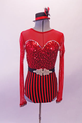 Red leotard has sequined sweetheart neckline edged with crystals, attached to a red sheer long sleeved upper & a low drop back. The high waisted brief is black & red vertical stripes. The back of the brief is layers of black & red fringe. Comes with striped footless fringed stockings, appliqued belt &  mini-top hat. Front