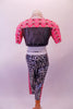 Two-piece football themed costume has a half top with a geometrical pattern of pinks & reds, Shoulders are padded with number “77” on the front & the back is a black leatherette mesh. The black & white shatter print ¾ leggings have a matching pink geometrical stripe on sides. Has black fingerless gloves & baseball cap. Back