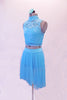 Two-piece aqua costume has floral lace high neck haft top with peek-a-boo back. Beneath the lace is an attached aqua camisole. The sheer mesh skirt aqua skirt is longer at the back and has an attached brief. Comes with a floral hair accessory. Side