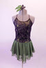 Olive-green based costume has black and pewter lace overlay top with princess seams and crystal covered cross back straps. Beneath the lace is an olive metallic base. The attached olive chiffon skirt has an attached brief. Comes with a floral hair accessory. Front