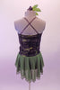 Olive-green based costume has black and pewter lace overlay top with princess seams and crystal covered cross back straps. Beneath the lace is an olive metallic base. The attached olive chiffon skirt has an attached brief. Comes with a floral hair accessory. Back
