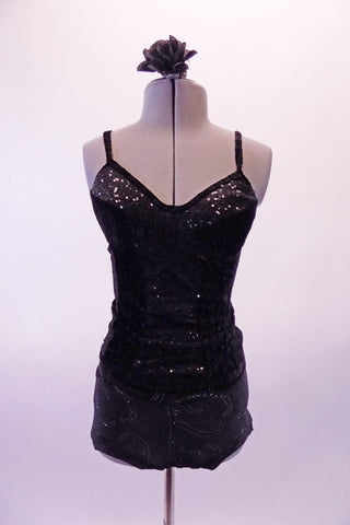 Black two-piece costume has black velvets swirl booty shorts. The matching top has a sequin and velvet front top with padded bra cups. The back has a full lace-up corset back. Comes with a black floral hair accessory. Front