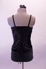 Black two-piece costume has black velvets swirl booty shorts. The matching top has a sequin and velvet front top with padded bra cups. The back has a full lace-up corset back. Comes with a black floral hair accessory. Back