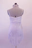 White leotard dress has white sheer, crystalled silver floral print with pinched double looped front and crystal covered straps.  A wide V band that extends from the front is covered with crystals that attach at the neck. Comes with a white floral hair accessory. Back