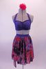 Three-piece costume has a navy-blue halter bra top with pinched front and matching briefs. The chiffon high-low skirt has a marbled pattern of blue, black and crimson to create the pop of colour. Comes with a crimson floral hair accessory. Front