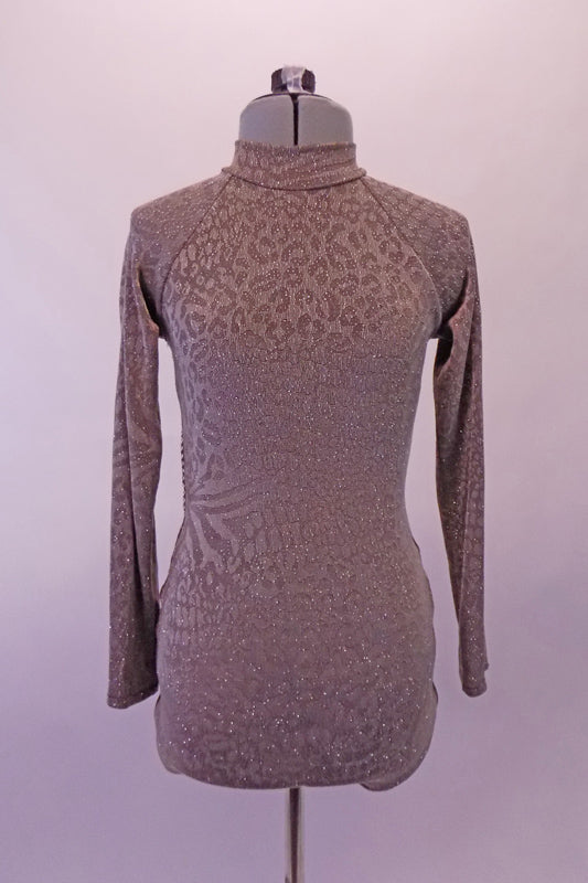 Elegant tone-on-tone taupe coloured leotard has a shimmery animal print. The bottom is a lower brief cut. The high, closed neck and long sleeves give rise to the fully open pack lined with crystals and reinforced with horizontal clear straps. Comes with a hair accessory. Front