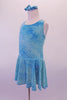 Dress has marbled and crackled look in shades of aqua blue crinkle chiffon with scattered glitter throughout. The wide cross-back straps and built-in brief keep the dress in place. Comes with matching hair accessory. Side