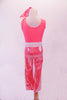 Coral crystalled tank top with scoop back is accompanied by coral shimmery pants. A white leatherette laser cut lace belt and matching wristbands accent the outfit. Comes with matching hair scarf. Back