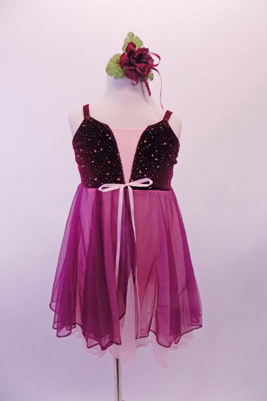 Sweet pink and burgundy dress has a burgundy velvet bust with scattered sequins and pale pink bust.  The pink and burgundy chiffon skirt extends from below the bust. Comes with a burgundy floral hair accessory. Front