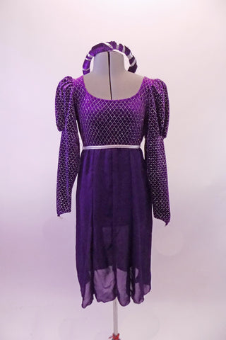 Purple medieval style dress has a silver diamond pattern on the velvet bodice and pouffe long sleeves. The purple knee length cotton skirt falls straight Comes with velvet wreath hair accessory. Front