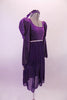 Purple medieval style dress has a silver diamond pattern on the velvet bodice and pouffe long sleeves. The purple knee length cotton skirt falls straight Comes with velvet wreath hair accessory. Side