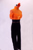 Orange and black unitard has a sheer orange mesh top with a built-in camisole beneath. The attached black velvet pants have a wide high-waist belt lined with orange crystals. The high collar also has a crystal design. Comes with an orange floral hair accessory. Side