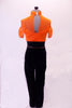 Orange and black unitard has a sheer orange mesh top with a built-in camisole beneath. The attached black velvet pants have a wide high-waist belt lined with orange crystals. The high collar also has a crystal design. Comes with an orange floral hair accessory. Back