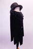 Quirky black velvet tunic style tailcoat has a faux collar and large front buttons. The black velvet ¾ length pants and black top hat create a fun yet creepy feel. Right side