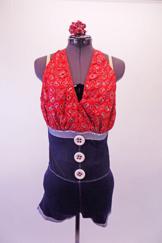 Red country-paisley patterned halter tie-neck unitard has an attached high waisted denim-like short that starts from just below the bustline and has large front button accents. The back pockets are lined with red crystals. Nude shoulder straps are attached for better support. Comes with matching hair accessory.  Front