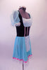 Ballet costume has teal velvet bodice with white lace bust and apron. The sheer aqua pouffe sleeves complement the aqua skirt. Pink ribbon detail accents the bodice and skirt edge. Wide white lace trim edges the skirt and sleeves. Comes with a white floral wreath accessory. Side