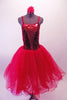Crimson red romantic tutu has long tulle skirt with a crushed velvet bodice. The front center of the torso is red sequin with a large red jewel brooch accent. The back has a nude panel with faux corset ties. Comes with a floral hair accessory. Front