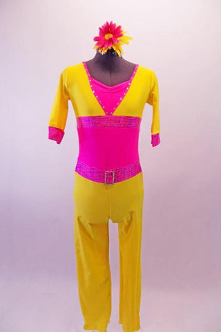 Bright yellow and neon pink ¾ sleeved unitard with a bright neon pink wide waistband. The pink flapped back pockets accent the yellow pants. Crystals line the collar and match the crystal belt buckle. Comes with a floral hair accessory. Front