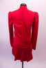 Red coat style uniform themed dress has a partial mandarin collar. Two large silver buckles adorn the left side of the dress at the bust and hip. The box pleat straight short skirt has a slit at the left side. Back