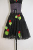 Black knee length layered crinoline skirt with grommets and 3D roses /leaves. Comes with a black bra  that has lace detailing and roses/leaves.bottom zoom