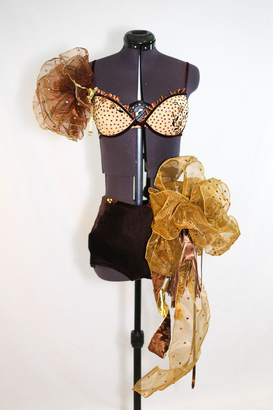 Caramel bra, brown velvet piping and flowers. Gold organza pouf on right shoulder. Shorts are brown velvet with crystal detail, large bow/pouf on the right hip, front