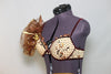 Caramel bra, brown velvet piping and flowers. Gold organza pouf on right shoulder. Shorts are brown velvet with crystal detail, large bow/pouf on the right hip, front zoom