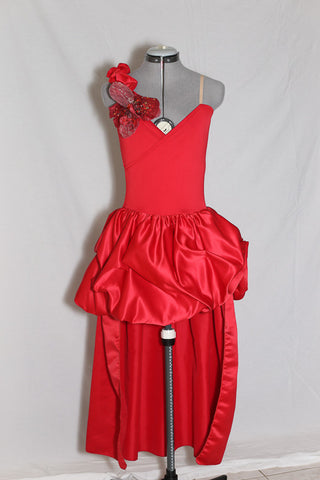 Red heavy sateen stretch fabric full dress. Skirt is open front, with large ruched bustle. Right shoulder is ruffled with a large flower crystal appliqué,  front