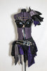 2 piece costume is comprised of a pleather bra with front cross straps Shoulder and hip have layers for purple/grey/ black taffeta & crystal covered hip-belt. Front