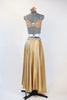 Gold shiny spandex brief, gold sequined bra and long flowing, ankle length, gold wrap skirt.skirt. with a gold hairpiece, full