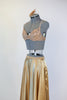 Gold shiny spandex brief, gold sequined bra and long flowing, ankle length, gold wrap skirt.skirt. with a gold hairpiece, side