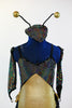 Black hologram spandex leotard has layers of gold and black ruffles. Comes with antennae hat and gantlets, front