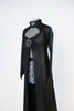 Long black leather-like coat  with large Swarovski broach accent. The coat is open in the front to reveal the snake-skin shorts. Side