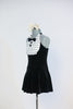 Black stretch velvet dress with attached panty has an ivory ruffled bib, black button and bow-tie accent. Comes with large, ivory bow, hair accessory. Side