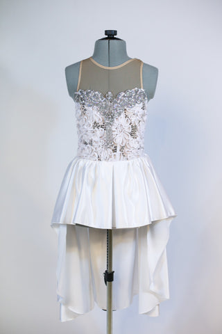 White rose fabric bodice is heavily embossed with large silver appliqués and crystals attached to white high-low skirt with pewter grey long bow at back, Front