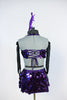 This costume is of jumbo sequined purple fabric.Has bra top with large broach detail, joined to purple panties and a pull-on skirt (gauntlets & head piece). Back