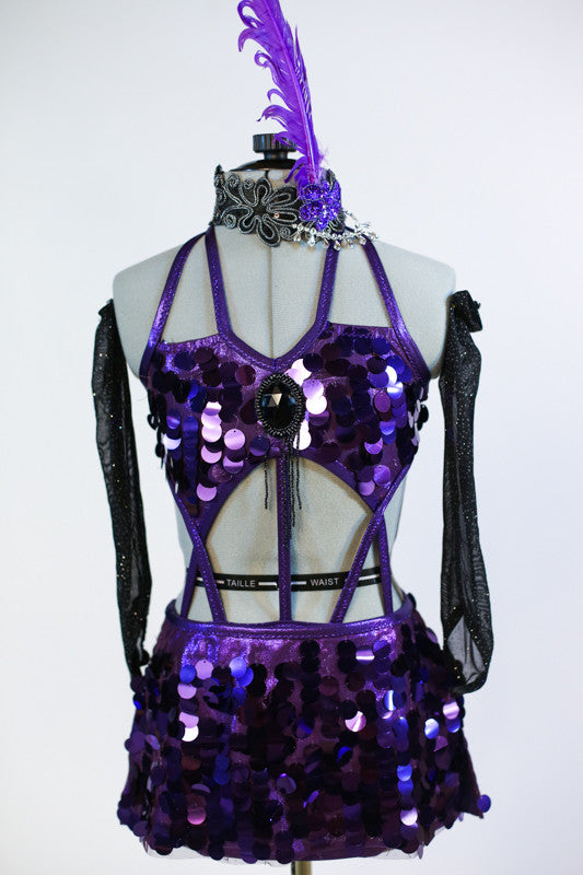 This costume is of jumbo sequined purple fabric.Has bra top with large broach detail, joined to purple panties and a pull-on skirt (gauntlets & head piece). Front Zoom