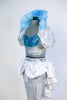 Costume includes a silver half-top with turquoise insert. Has with silver metallic leggings,white bustle skirt & detachable collar (with turquoise appliques). Side