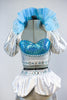 Costume includes a silver half-top with turquoise insert. Has with silver metallic leggings,white bustle skirt & detachable collar (with turquoise appliques). Front Zoom