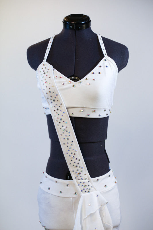 White velvet bra-top connected to white velvet short with crystal covered strap extending from the shoulder to opposite hip, that has white chiffon layers. Zoom