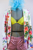 Pink metallic, lined, leather shorts, accompany a bright yellow bra with crystals and a silky floral jacket. Comes with a large aqua hair accessory. Zoomed